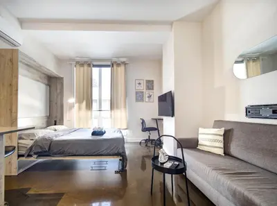 a bedroom with a bed and a couch in a room at Appartement au centre de Montréal in Montréal