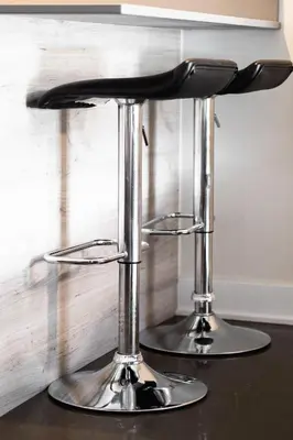 a chrome bar stool sitting on top of a table at Appartement au centre de Montréal in Montréal