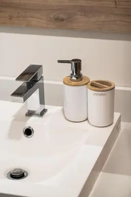a bathroom sink with two containers on top of it at Appartement au centre de Montréal in Montréal