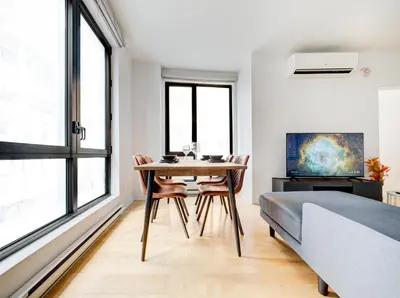 a bedroom with a dining room table and a bed at Charmant appartement au vieux port de Montréal in Montréal