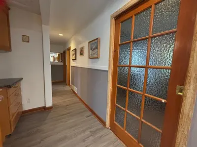 a hallway with a glass door in a kitchen at Entire floor in a Spacious bungalow ensuite close to beach and train in Pincourt