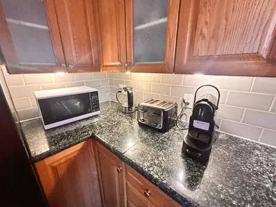 a kitchen counter with a blender and a toaster at Entire floor in a Spacious bungalow ensuite close to beach and train in Pincourt