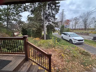 a white car parked on the side of a driveway at Entire floor in a Spacious bungalow ensuite close to beach and train in Pincourt
