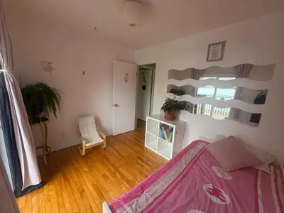 a living room with a bed and a window at Escapade familiale à Longueuil in Longueuil