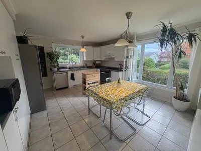 a kitchen with a table with a table cloth on it at Escapade familiale à Longueuil in Longueuil