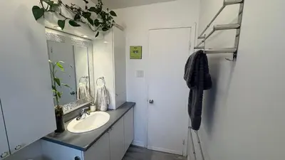 a bathroom with a sink and a mirror at Escapade familiale à Longueuil in Longueuil