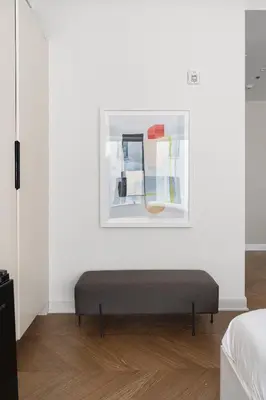 a bed in a room with a painting on the wall at Nomade Saint Paul in Montréal