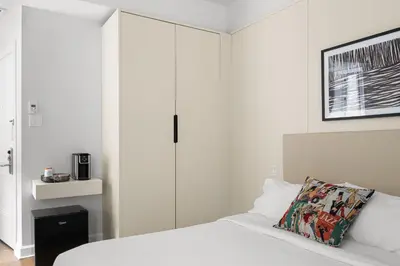 a bedroom with white cabinets and a bed with a pillow at Nomade Saint Paul in Montréal