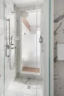 a bathroom with a shower with a glass door at Nomade Saint Paul in Montréal