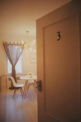 a door leading into a dining room with a table at Gite La Cache in Beloeil Village