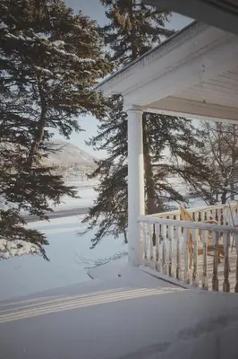 a porch of a house with snow on it at Gite La Cache in Beloeil Village