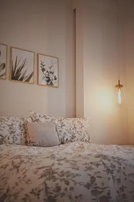 a bedroom with a bed and some pictures on the wall at Gite La Cache in Beloeil Village