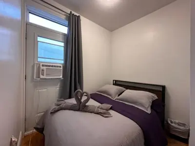 a bedroom with a bed with a towel on it at FULL KITCHEN 10min from DTOWN Room B in Montréal