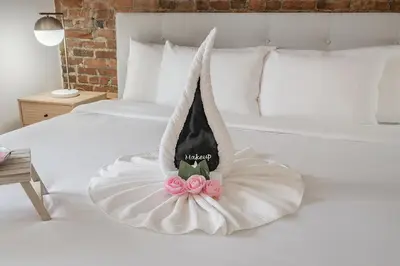 a white bed with a dress on top of it at Charming Family Escape in Trendy Plateau Montreal in Montréal