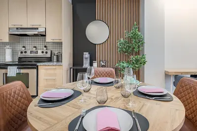 a dining room table with glasses and plates on it at Charming Family Escape in Trendy Plateau Montreal in Montréal