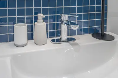 a bathroom sink with toothbrushes and a faucet at Charming Family Escape in Trendy Plateau Montreal in Montréal