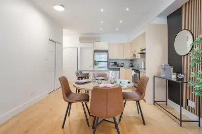a kitchen and dining room with a table and chairs at Charming Family Escape in Trendy Plateau Montreal in Montréal