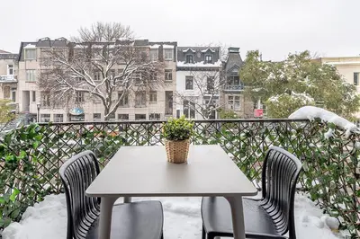 a table and chairs with a potted plant on a balcony at Charming Family Escape in Trendy Plateau Montreal in Montréal