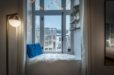 a window with a white window seat in a room at Charming Family Escape in Trendy Plateau Montreal in Montréal