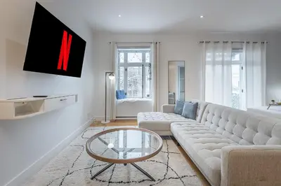 a living room with a couch and a glass table at Charming Family Escape in Trendy Plateau Montreal in Montréal