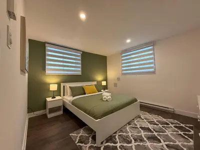 a bedroom with a bed with a teddy bear on it at Beautiful Spacious 4BR with Parking, Near Montreal in Longueuil