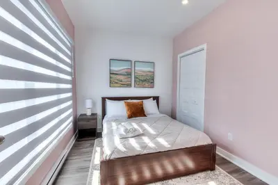 a small bedroom with a bed and a window at Modern Comforts 3 Bedroom & Full Kitchen & Wifi & Easy Montreal Access in Longueuil