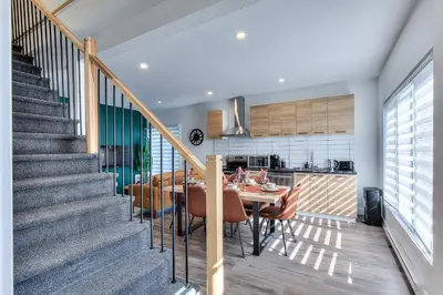 a dining room and kitchen with a table and chairs at Modern Comforts 3 Bedroom & Full Kitchen & Wifi & Easy Montreal Access in Longueuil