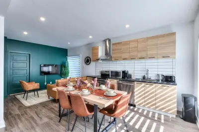 a kitchen and dining room with a table and chairs at Modern Comforts 3 Bedroom & Full Kitchen & Wifi & Easy Montreal Access in Longueuil