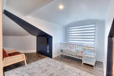 a baby room with a crib and a window at Modern Comforts 3 Bedroom & Full Kitchen & Wifi & Easy Montreal Access in Longueuil