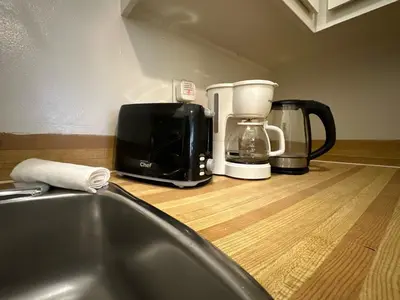 a kitchen counter with appliances on a wooden counter top at Guy Concordia! Nightlife! Downtown's Essentials! Best City Spot! in Montréal