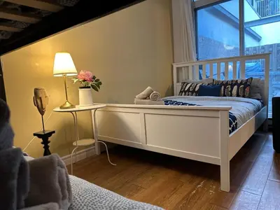 a bedroom with a white bed and a window at Guy Concordia! Nightlife! Downtown's Essentials! Best City Spot! in Montréal