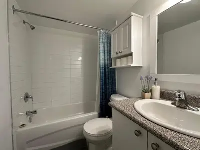 a white bathroom with a sink and a toilet and a tub at Guy Concordia! Nightlife! Downtown's Essentials! Best City Spot! in Montréal
