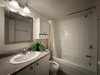 a bathroom with a sink and a toilet and a mirror at Guy Concordia! Nightlife! Downtown's Essentials! Best City Spot! in Montréal