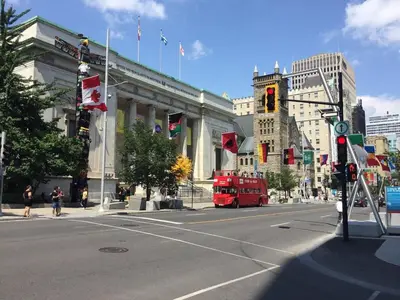a red double decker bus driving down a city street at Guy Concordia! Nightlife! Downtown's Essentials! Best City Spot! in Montréal