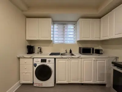 a kitchen with a washing machine and a sink at Cute & Cozy Hub for Montreal Travelers in Montréal