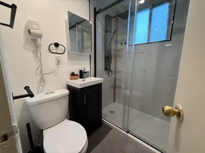 a bathroom with a shower and a toilet and a sink at Cute & Cozy Hub for Montreal Travelers in Montréal