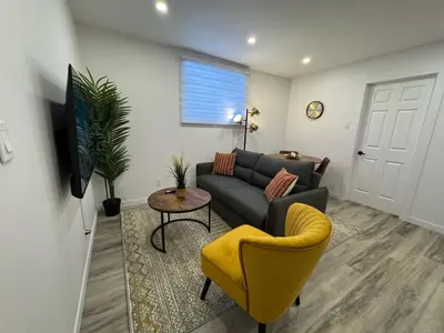 a living room with a couch and a yellow chair at Cute & Cozy Hub for Montreal Travelers in Montréal