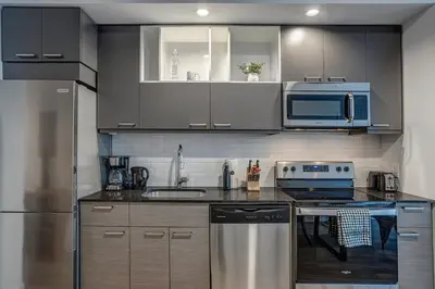a kitchen with a sink and a stove top oven at Montreal - C Lofts Le Smith - 2B1B 1006 in Montréal