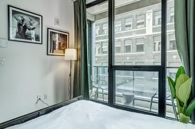 a bedroom with a bed and a large window at Montreal - C Lofts Le Smith - 2B1B 1006 in Montréal