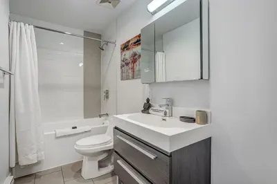 a white bathroom with a sink and a toilet at Montreal - C Lofts Le Smith - 2B1B 1006 in Montréal