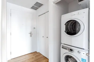 a white laundry room with a washer and dryer at Montreal - C Lofts Le Smith - 2B1B 1006 in Montréal