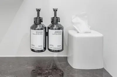 two bottles of soap sitting next to a soap dispenser at Historic Old Montreal Stay - Iconic Location in Montréal
