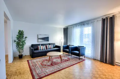 a living room with a couch and a table at Beautiful and Cozy 3BR in Montreal West Island in Montréal