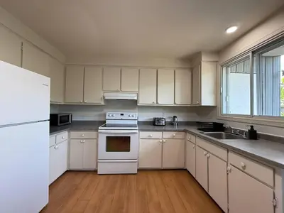 a kitchen with white appliances and a white refrigerator at Beautiful and Cozy 3BR in Montreal West Island in Montréal