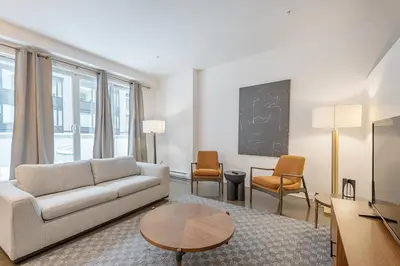 a living room with a couch and a table at Chic Old Montreal Retreat - Iconic Location in Montréal