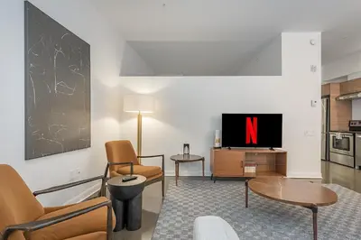 a living room with a tv and a table and chairs at Chic Old Montreal Retreat - Iconic Location in Montréal