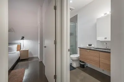 a bathroom with a toilet and a sink and a shower at Chic Old Montreal Retreat - Iconic Location in Montréal