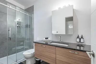a bathroom with a toilet and a sink and a shower at Chic Old Montreal Retreat - Iconic Location in Montréal