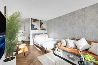 a living room with a couch and a bed at The Speakeasy Suite 503 With Parking in Montréal