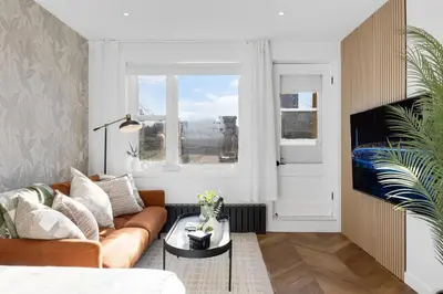 a living room with a couch and a table at The Speakeasy Suite 503 With Parking in Montréal
